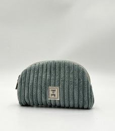 A mint green corduroy vanity bag with a waterproof interior, perfect for storing makeup and other essentials.
