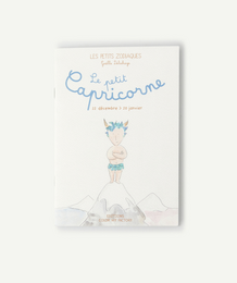 A children's book titled "Little Capricorn - birth and birthday gift" featuring a whimsical illustration of a young child with a unicorn horn on their head standing in a snowy, mountainous landscape.