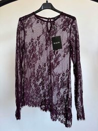 Purple lace long sleeve top, delicate floral pattern, asymmetrical hem, elegant sheer fabric.