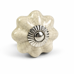 Cream porcelain flower-shaped cabinet knob with crackle finish and metal center detail.