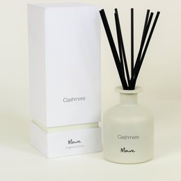 Fragrance diffuser sticks in a cashmere scent. The diffuser features a white glass bottle with black reed sticks. The product is designed for home fragrance.