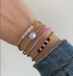 Satin cord bracelets in brown, beige, and green colors. The bracelets feature a simple, minimalist design with metal accents.