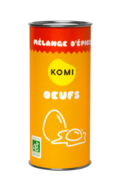 A tin of Mélange d'épices pour Oeufs, a seasoning blend for eggs. The tin features the word "KOMI" and an illustration of an egg.