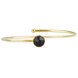 Gold bracelet with a black onyx stone, suitable for children. The bracelet features a simple, elegant design with a single round black onyx stone set in a gold band.