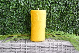  Large, handmade beeswax pillar candle in a vibrant yellow color.