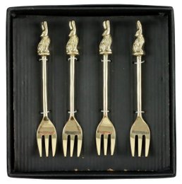 A set of 4 gold-colored forks with bunny-shaped handles, presented in a black display box.