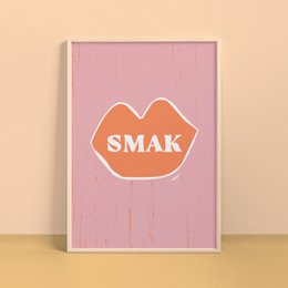  A vibrant pink poster featuring the word "SMAK" in an orange, stylized font. The poster has a minimalist, modern design that would complement a variety of home decor styles.