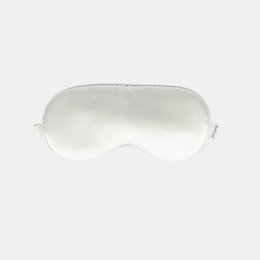 Ivory white sleep mask, soft padded eye cover, rounded contoured shape, adjustable straps, comfortable bedtime accessory