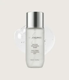 Lightweight white tonic lotion, silver metallic cap, delicate skincare formula, brightening treatment.