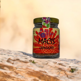 Granulated organic mace spice in a glass jar with a vibrant red and orange label.