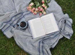 Soft, cozy throw blanket in a neutral eggshell white color, handmade with a natural, beachy aesthetic. Ideal for relaxing or decorating.