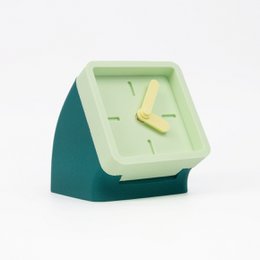 Petrol green and mint colored table clock with a minimalist, geometric design.