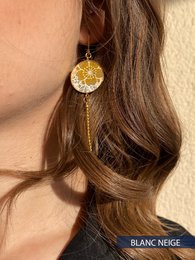 Elegant drop earrings with a round, gold-toned pendant and a delicate chain. Available in various color variants.
