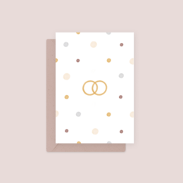 White greeting card with gold wedding rings and polka dot pattern, suitable for wedding or engagement celebrations.