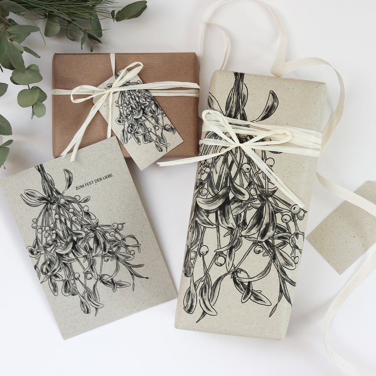 Gift tags made from grass paper, mistletoe