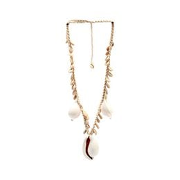 A long necklace with a braided cord and various charms, including a cowrie shell, feathers, and other natural elements.