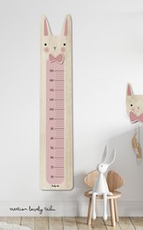 Wooden rabbit-themed growth chart for kids' room, featuring a cute rabbit design and measurement markings. Ideal for tracking child's height development.