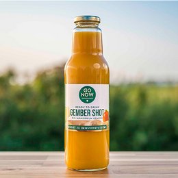 Mandarin-Ginger 750ml | Ginger Shot | Ginger Juice | Ginger. A vibrant orange-colored ginger juice with a blend of mandarin and ginger flavors. The juice is packaged in a glass bottle with a gold-colored cap.