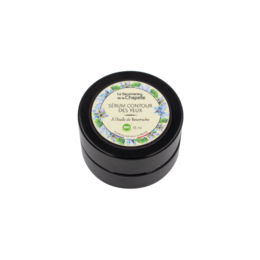 Eye contour serum in a black jar with green and white label. Moisturizing and nourishing formula for the delicate eye area.