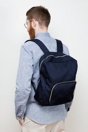 Navy blue backpack with multiple compartments and adjustable straps for comfortable carrying.