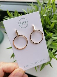 Shiny gold statement earrings with circular hoops.