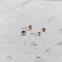Silver and bronze stud earrings, minimalist and eco-friendly design.