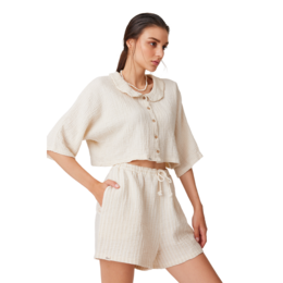  Lightweight, textured cotton shorts in a neutral beige color with a drawstring waist for a relaxed, casual style.