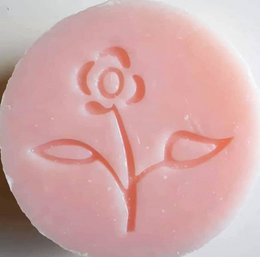 Rose-scented soap bar, 35g, with a floral design embossed on the surface.