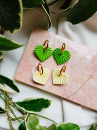 "Boho heart-shaped earrings, metallic green and pastel yellow, statement jewelry with leaf design"