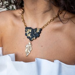 Gold-toned floral chain necklace with pendant.
