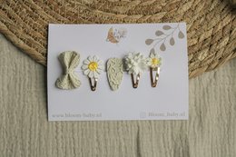 A set of 8 colorful hair clips featuring various shapes and designs, including bunnies, flowers, and leaves, suitable for kids.