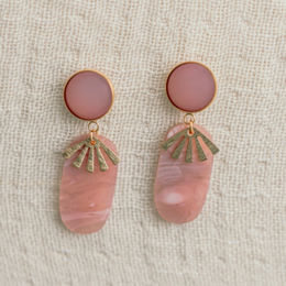 Statement earrings with round pink studs and dangling pink quartz-like stones. Features a modern, minimalist design.