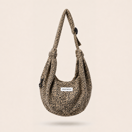 Leopard print shoulder bag, adjustable straps, beige black panther pattern, soft fabric, pet carrier.