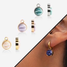 Colorful, round charms in various metal finishes (silver, rose gold, gold) that can be used to create custom hoop earrings. The charms feature a variety of shapes and colors, including pink, blue, and white.