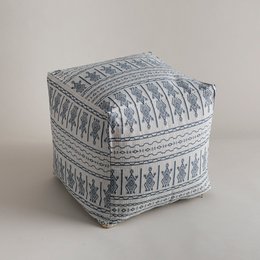 A square-shaped pouf with a patterned, textured fabric in shades of blue and white. The pattern features intricate geometric designs and tribal-inspired motifs, giving the pouf a rustic, bohemian aesthetic.