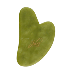 Jade gua sha stone for facial massage, anti-aging, and dry/impure skin. Oval-shaped, green jade stone with smooth, curved surface for gentle facial massage and skin rejuvenation.