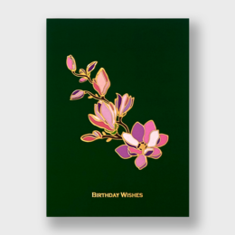  A birthday card featuring a bouquet of pink and gold magnolia flowers on a dark green background. The card is titled "Birthday Wishes".