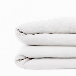 Gingham organic cotton duvet cover in a soft peach color, featuring a classic gingham pattern. The duvet cover is made of high-quality organic cotton for a comfortable and sustainable sleep experience.