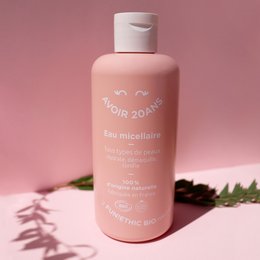 Cosmos Organic 100% Natural Micellar Water, a revitalizing and moisturizing complexion radiance product. The bottle is pink in color with a white cap.