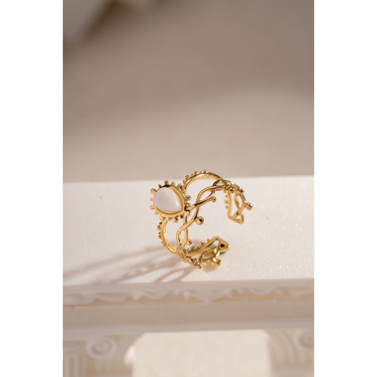 Golden stalen ring geopend met kleurrijke steen
