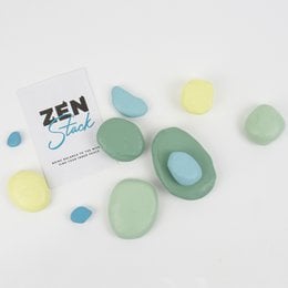 Zen art stacking game with smooth, colorful stones in various shades of green, blue, and yellow. Stones can be stacked in different configurations to create calming, meditative displays.