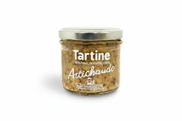 Artichoke tapenade spread, chunky texture, golden-brown color, glass jar with metal lid, French gourmet food product.