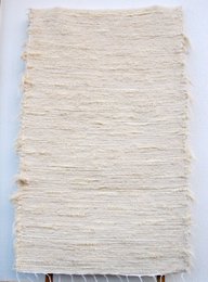 Crèmekleurig katoenen vloerkleed van medium 140/70 cm