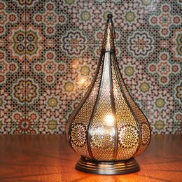  Ornate gold-toned table lamp with intricate perforated metal shade, providing a warm, ambient glow.