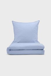  Light blue chambray bed linen set, soft woven cotton material, smooth texture, modern minimalist style.