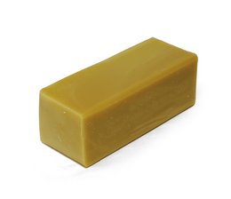 Large 1kg bar of Argan Ylang Ylang scented soap. Rectangular shape with smooth, golden-yellow color.