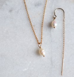 A delicate gold-filled or 925 sterling silver choker necklace with two small pearl pendants.