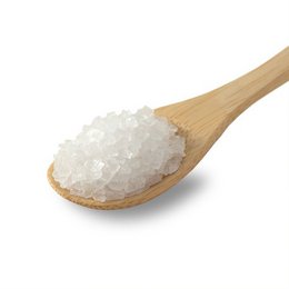 Halite salt crystals in a wooden spoon, approximately 3-5 mm in size, suitable for use in salt mills.