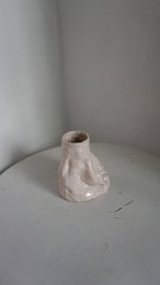 A handmade, matte gray vase with a simple, cylindrical shape.