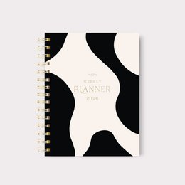  A spiral-bound A6 planner for 2026 with a bold, abstract black and white pattern design. The planner is categorized as a weekly planner.